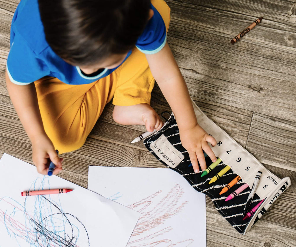 boy coloring with crayons, crayon holder
