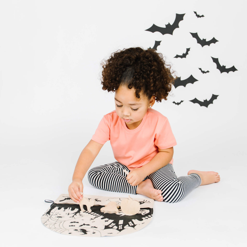 girl playing with halloween toys