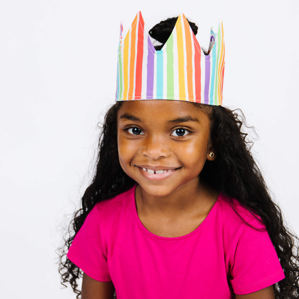 girl wearing rainbow stripe crown