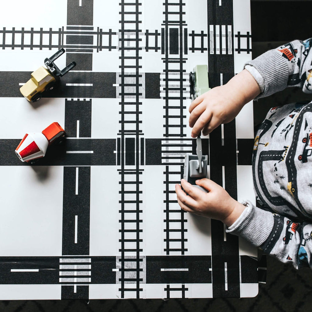 toddler playing with train toys