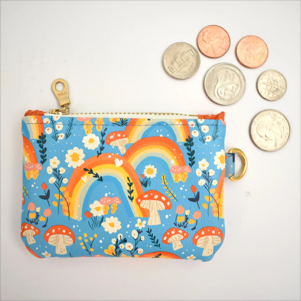 Coin purse with rainbow and mushroom design on a white background