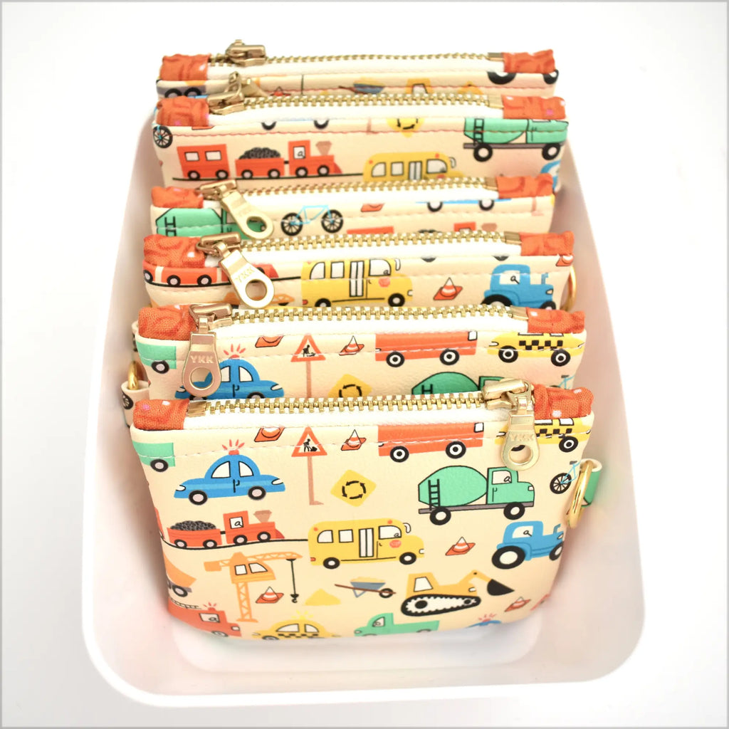 Set of small pouches with vehicle pattern on a white background