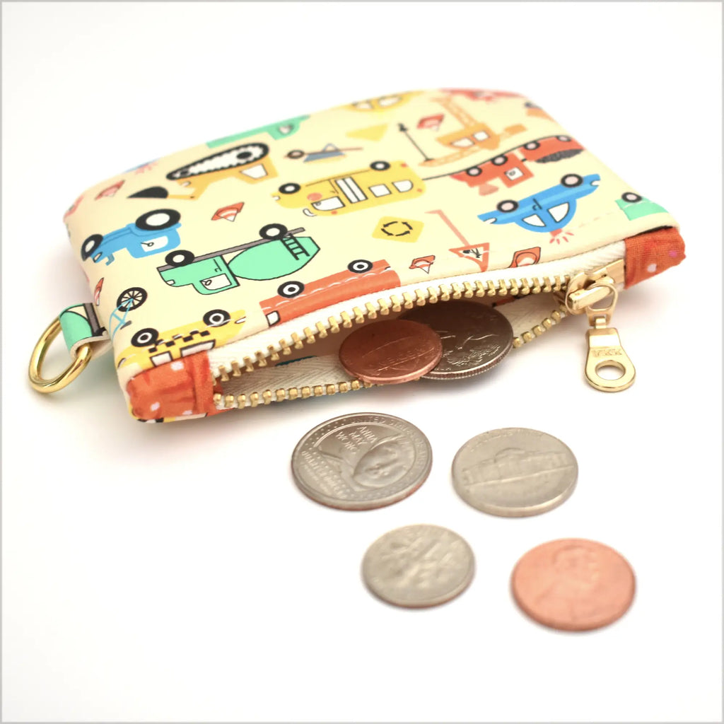 Colorful coin purse with construction vehicles pattern on a white background