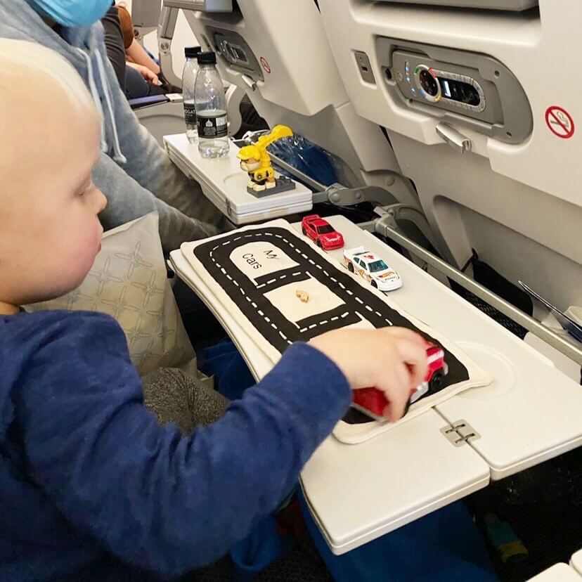 toy car storage, kid playing with toy cars on plane, toys for travel