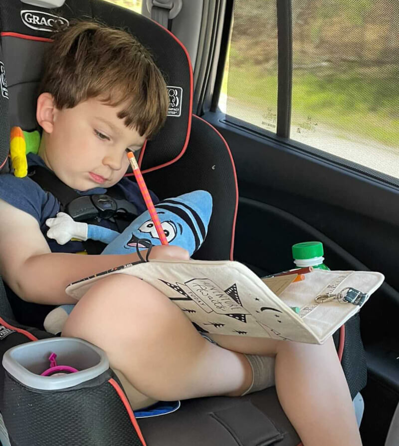 kid drawing in car seat, toys for travel