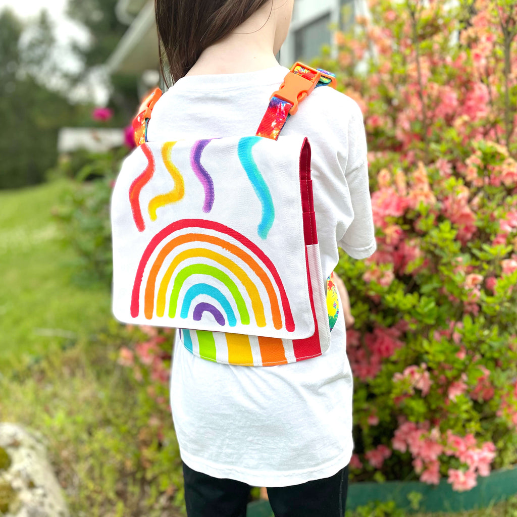 my daughter loves wearing rainbow backpack