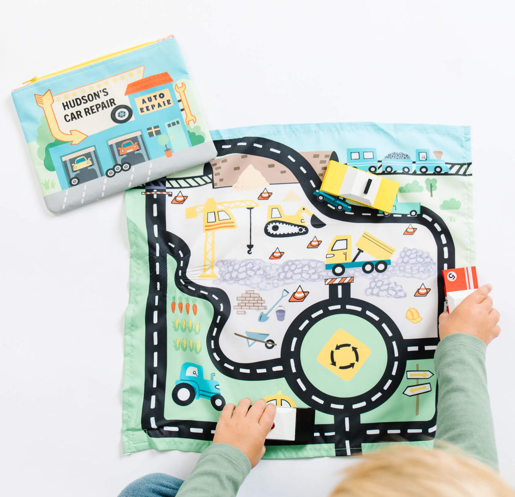 Kids playing with toy cars on play mat by So Handmade