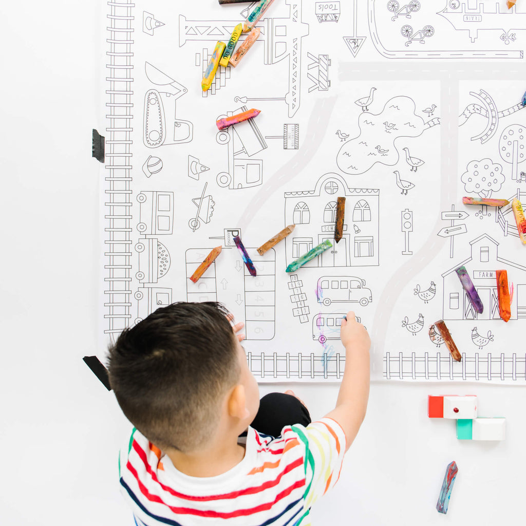 boy coloring a giant coloring page