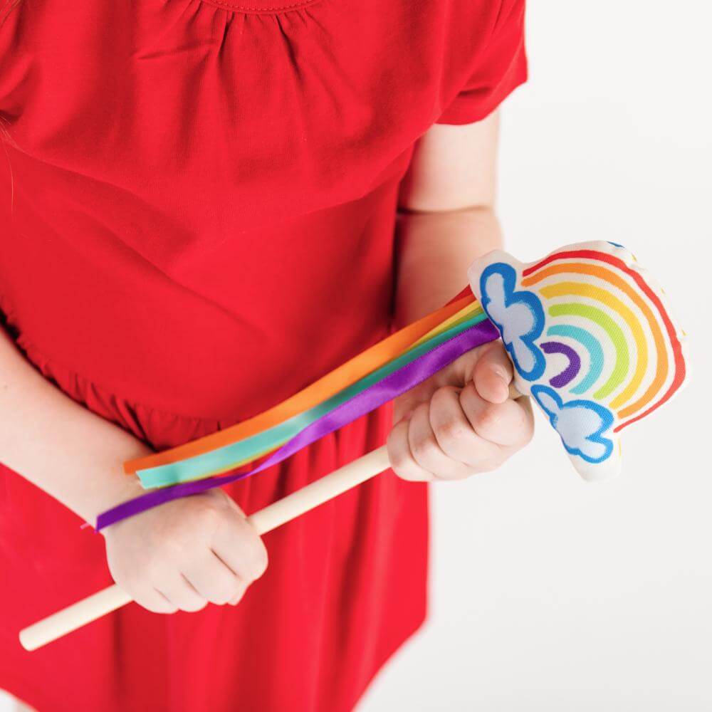 girl holding rainbow magic wand